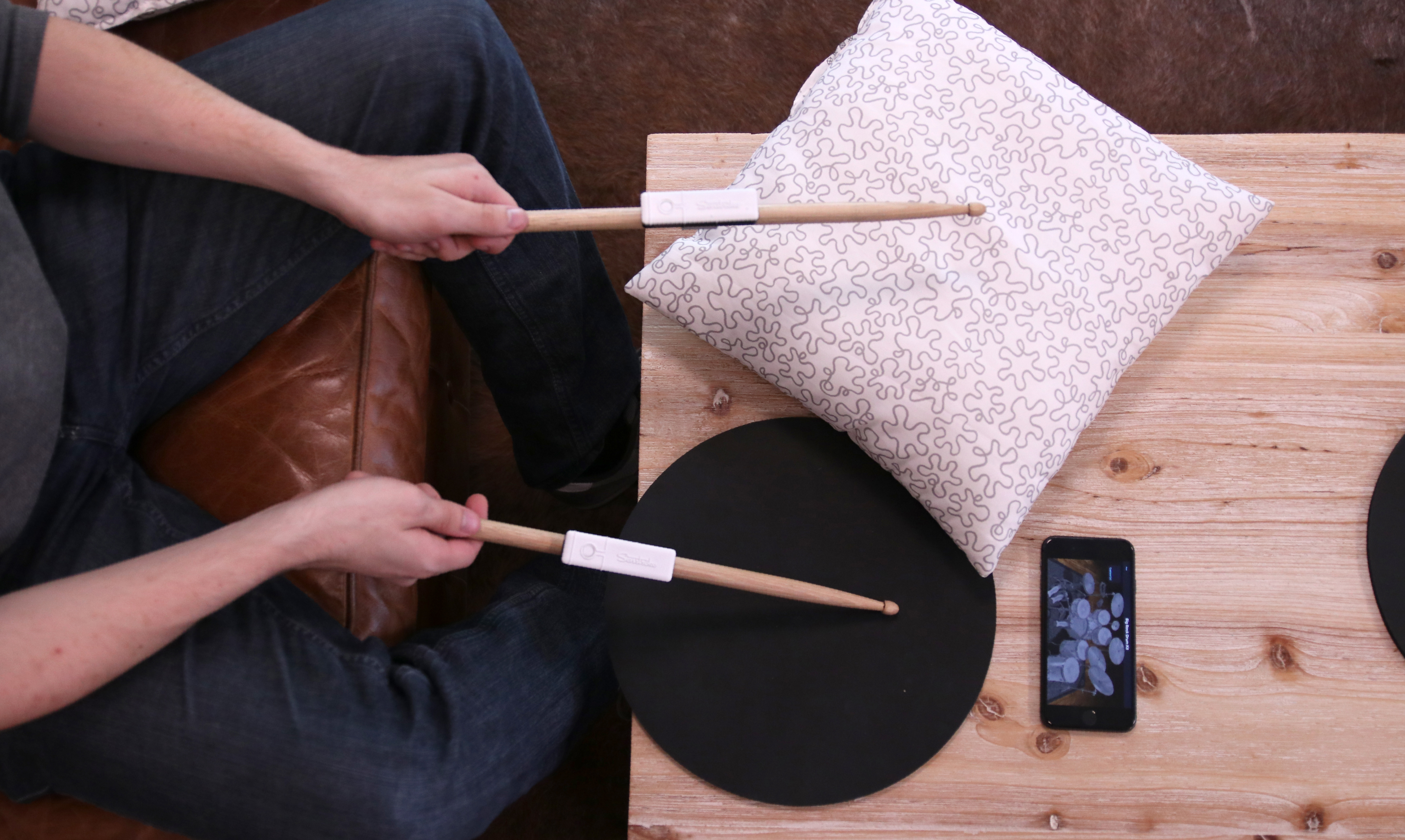 senstroke on table with cushion drumming pad and smartphone app